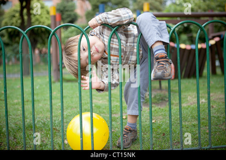 Boy playing with ball on playground Stock Photo