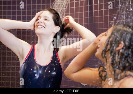 Smiling women showering in pool Stock Photo - Alamy