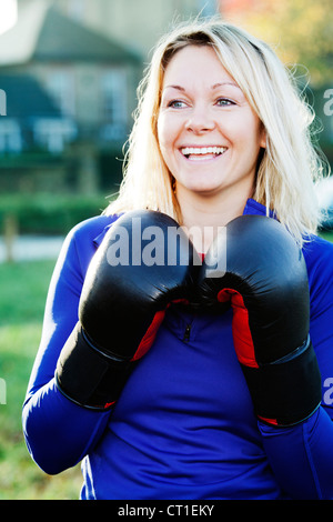 Boxer holding up gloves outdoors Stock Photo