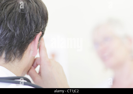 Close up of mans ear and finger Stock Photo