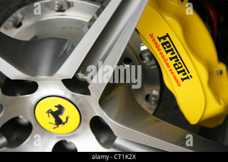 Yellow Brembo brake calipers on Ferrari sportscar. Stock Photo