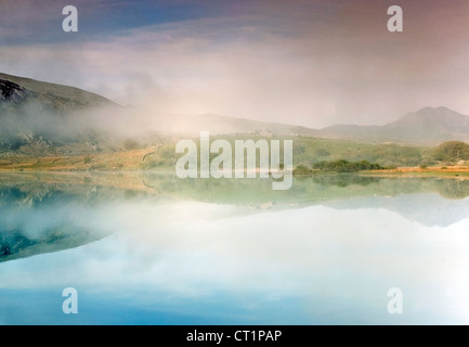 Morning mist on Llyn Mymbyr near Capel Curig Snowdonia National Park Gwynedd North Wales UK, Late Spring. Stock Photo