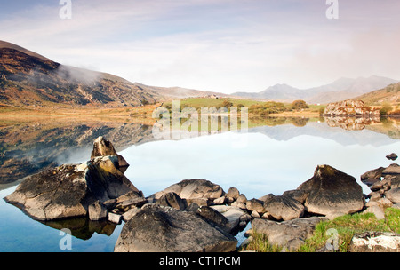Rocky shores of Llyn Mymbyr Capel Curig, Snowdonia National Park Gwynedd North Wales UK, Late Spring. Stock Photo