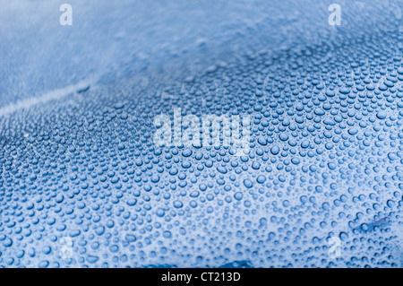 drops of rain on a blue metal surface Stock Photo