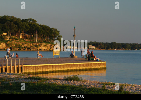 Fishing from the pier during a Lake Erie Sunset. From Catawba Island State Park, Catawba Island, Port Clinton, Ohio, USA. Stock Photo