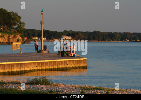 Fishing from the pier during a Lake Erie Sunset. From Catawba Island State Park, Catawba Island, Port Clinton, Ohio, USA. Stock Photo