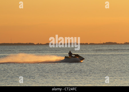 Man on Sea Doo and Lake Erie Sunset. From Catawba Island State Park, Catawba Island, Port Clinton, Ohio, USA. Stock Photo