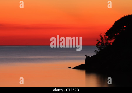 Lake Erie Sunset. From Catawba Island State Park, Catawba Island, Port Clinton, Ohio, USA. Smooth water due to long exposure. Stock Photo