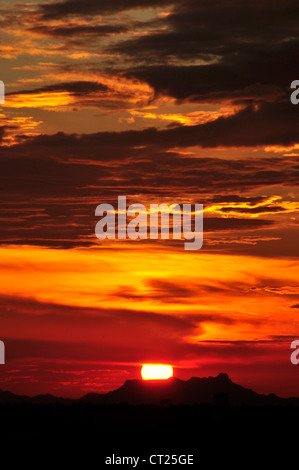 A sunset colors the sky during monsoon season in the Sonoran Desert,Tucson, Arizona, USA. Stock Photo