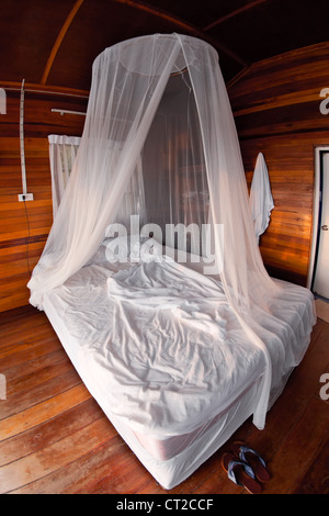 Mosquito net on the bed in Thai bungalow Stock Photo