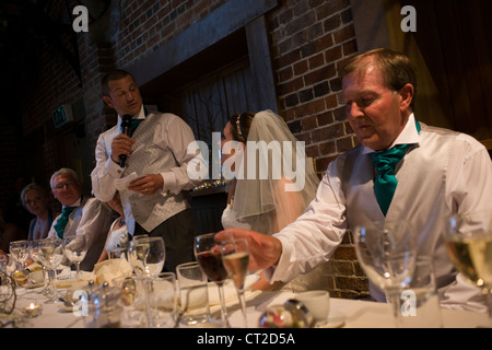 Groom shares love for his new bride and tells jokes during reception after a civil wedding ceremony in Essex. Stock Photo