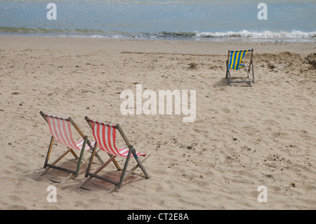 Deckchairs on Swanage beach Stock Photo