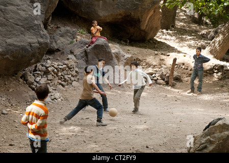 Moroccan children in the High Atlas mountains playing football ( Soccer ), Morocco Africa Stock Photo