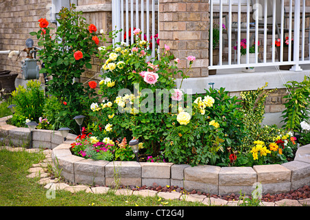 Natural stone landscaping in home rose garden Stock Photo