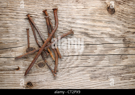 Old rusty nails on wood background Stock Photo