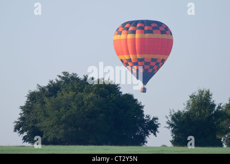 Hot air Balloon flies over Polk County, Florida in the early morning. Stock Photo