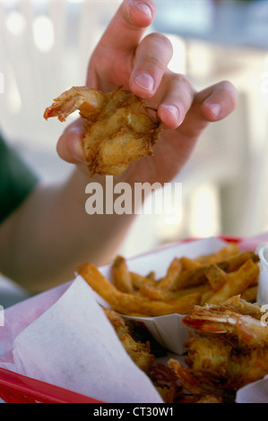 A man holding shrimp and chips in the Florida Keys. Stock Photo