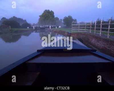 Barge boat moored on a canal near a lock in the autumn near Bradford-on-Avon Stock Photo