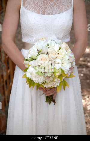 A bride is holding her bouquet of flowers. Stock Photo