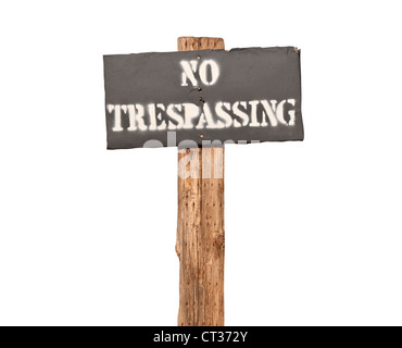 Funky stenciled no trespassing sign on wooden post.