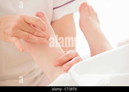 Woman having foot massage in spa Stock Photo