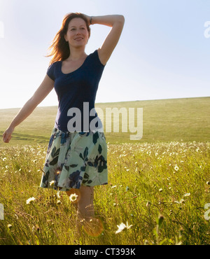 Woman walking in tall grass Stock Photo