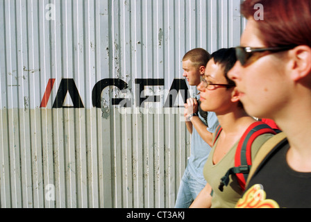 Poznan, youths walk past advertising AGFA Stock Photo