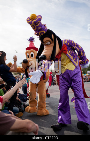 Goofy and Pluto shaking hands of visitors during a street parade in Magic Kingdom, Disney World, Orlando, Florida Stock Photo