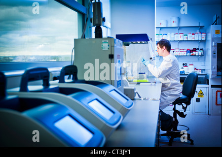 Scientist using computer in lab Stock Photo