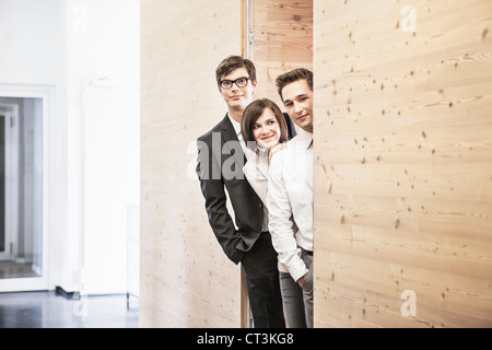 man peeking around the corner of an office cubicle Stock Photo - Alamy