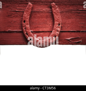 The old horseshoe hanging on wooden wall on a white background Stock Photo