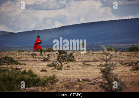 Man walking across dry terrain Stock Photo