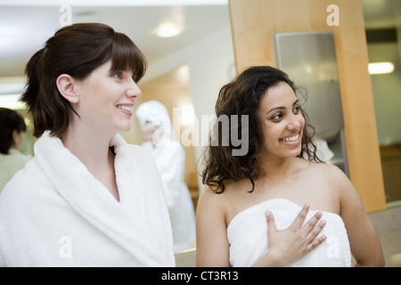 Women wearing towels in locker room Stock Photo