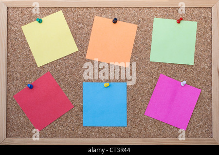 Cork board with six blank colorful sticky notes Stock Photo