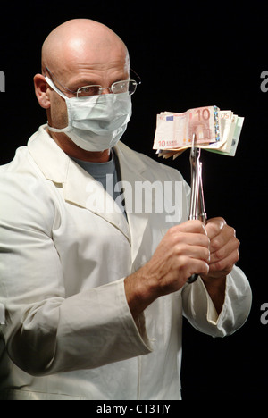 Hamburg, A surgeon holds a pair of pliers with banknotes Stock Photo