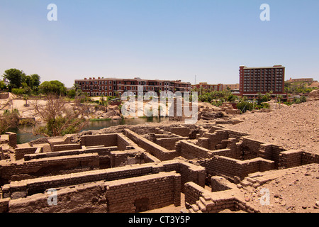 Nubian ruins on Elephantine Island in Aswan Egypt with the Old Cataract Hotel in background Stock Photo