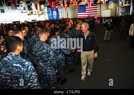Former President George W. Bush shakes hands with Sailors aboard the Navy's newest aircraft carrier, the USS George H.W. Bush during a visit to the ship June 10, 2012 in the Atlantic Ocean .