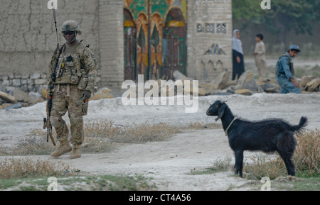 U.S. Army Sgt. 1st Class Marlon Green, a native of Houston and 3rd Platoon sergeant, Alpha Battery, 2nd Battalion (Airborne), 377th Parachute Field Artillery Regiment, pulls security in front of a doctorâ€™s qalat in the village of Kunday July 7, 2012. PFARâ€™s mission was to facilitate members of the female engagement team as they conducted key leader engagements to promote a female health education program. Stock Photo