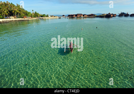 Malaysia, Borneo, Semporna, Mabul, fishermen in canoe in transparent turquoise sea Stock Photo