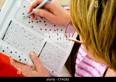 ELDERLY P. DOING CR-WORD PUZZLE Stock Photo