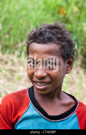 Indonesia, Papua New Guinea, Fergusson Island. Close-up shot of young boy. Stock Photo