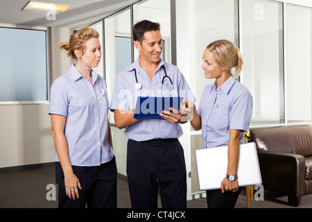 Young doctor with two attractive nurses Stock Photo