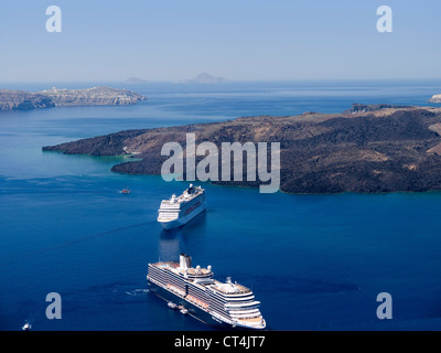 View of Cruise Ships in the sea filled the Caldera below Fira the Capital of Santorini Greece Stock Photo