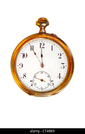 Beautiful old pocket watch in brass case, with hands showing five minutes before twelve Stock Photo