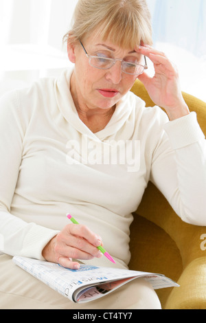 ELDERLY P. DOING CR-WORD PUZZLE Stock Photo