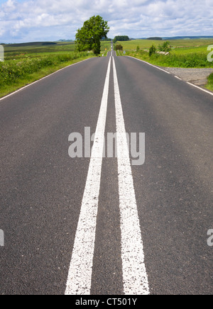 The very straight Military Road originally built by the romans that runs alongside Hadrian's Wall in Northumberland, England. Stock Photo