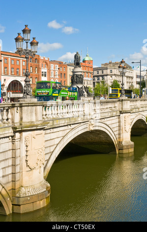 The O'Connell bridge and monument behind on O'Connell street across the Liffey river in the center of Dublin. Stock Photo