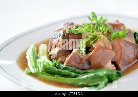 stewed pork knuckle with kale inside on white background Stock Photo
