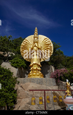 Ornate golden multi faced female deity figure with many arms at Khao Takiab Buddhist Chinese temple Hua Hin Thailand S. E. Asia Stock Photo