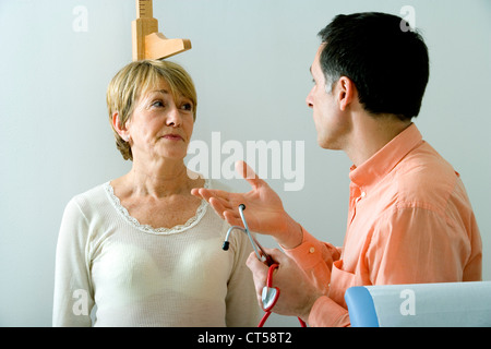 MEASURING HEIGHT, ELDERLY PERSON Stock Photo